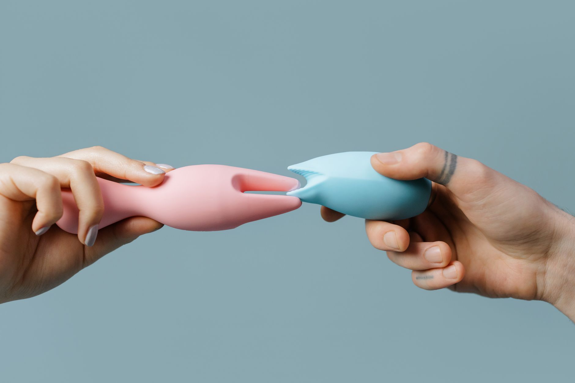 Woman holding a blue and pink silicone vibrator, representing body reconnection and healing